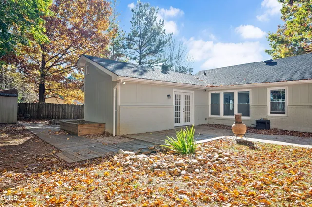 a white house that has a tree in front of it