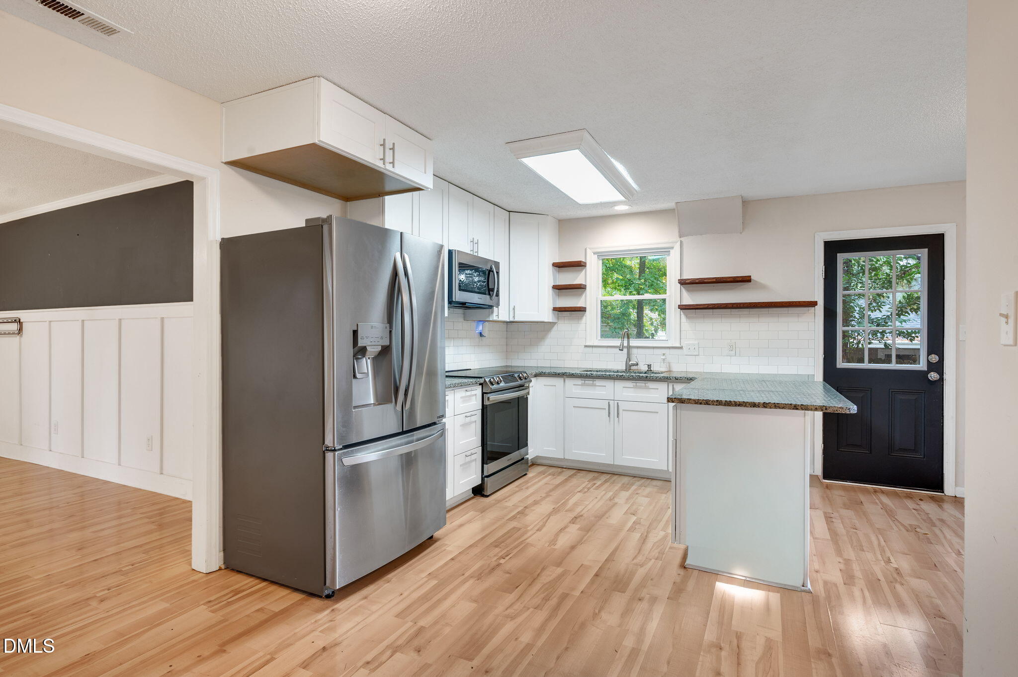 102 Castill Place Garner, NC 27529 - Photo 5 of 37 a kitchen with granite countertop a refrigerator and wooden floors