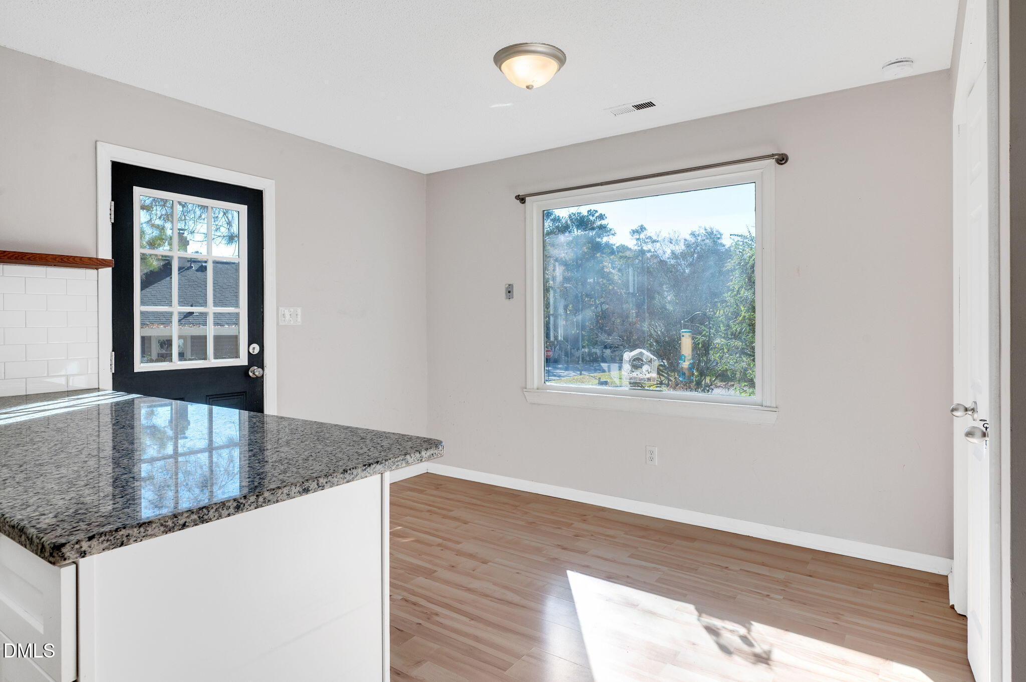 102 Castill Place Garner, NC 27529 - Photo 7 of 37 wooden floor in an empty room with a window