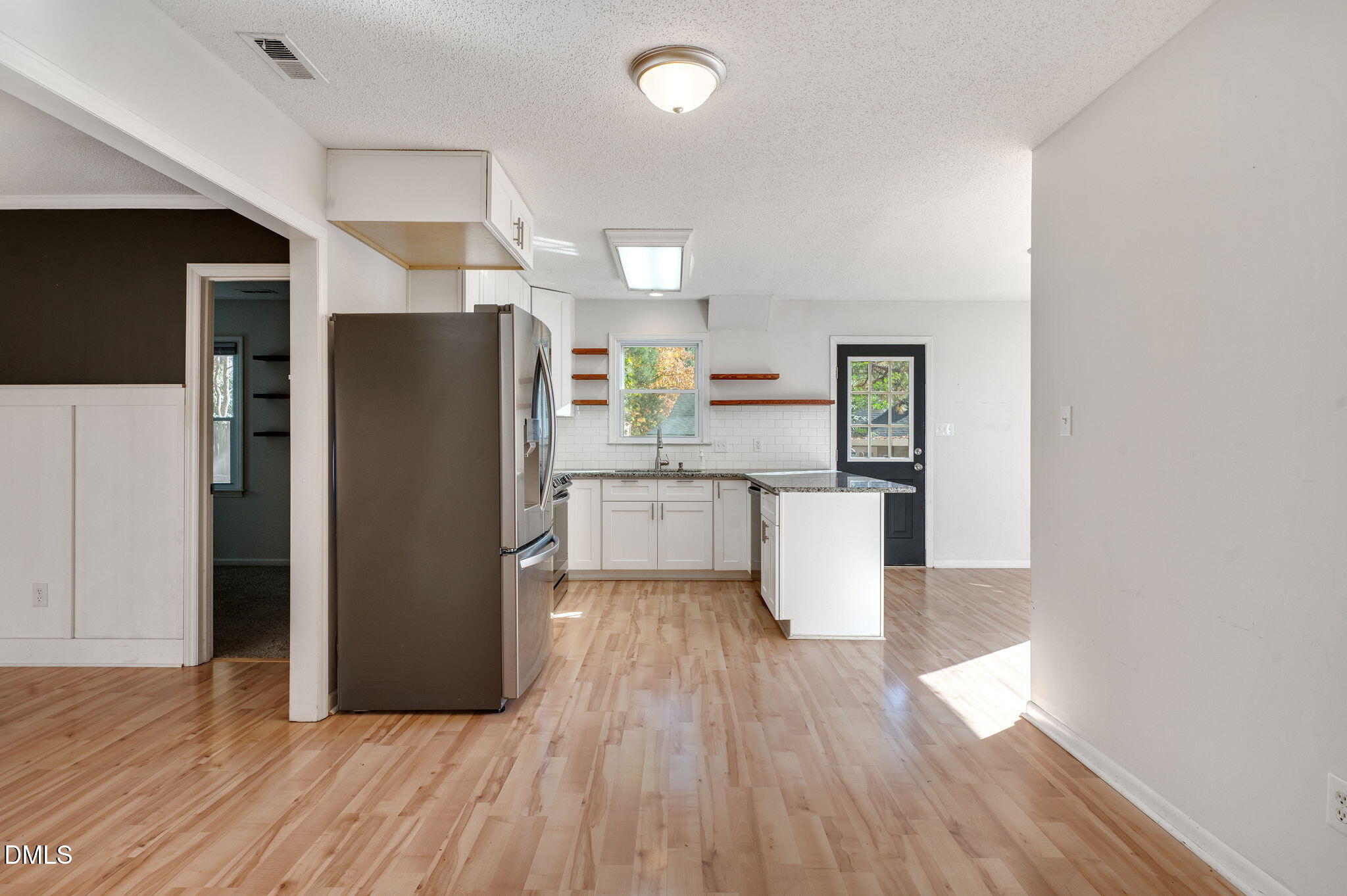 102 Castill Place Garner, NC 27529 - Photo 9 of 37 a kitchen with stainless steel appliances a refrigerator and wooden floor