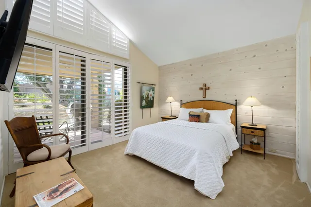 a spacious bathroom with a granite countertop sink and a mirror