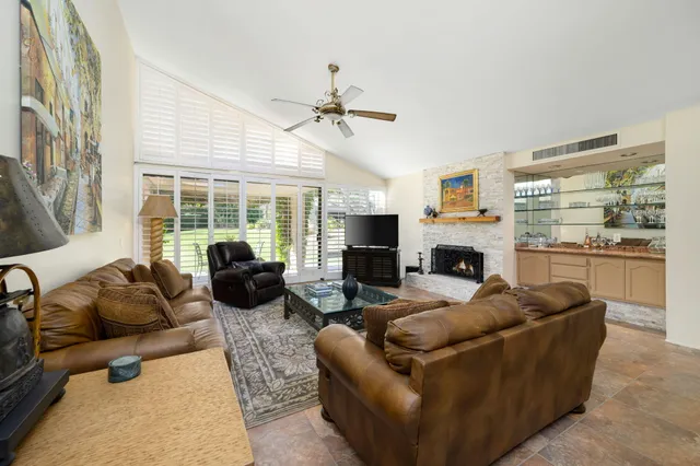a kitchen with granite countertop a refrigerator and a stove top oven
