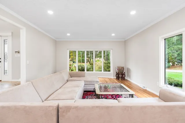 a living room with furniture and floor to ceiling windows