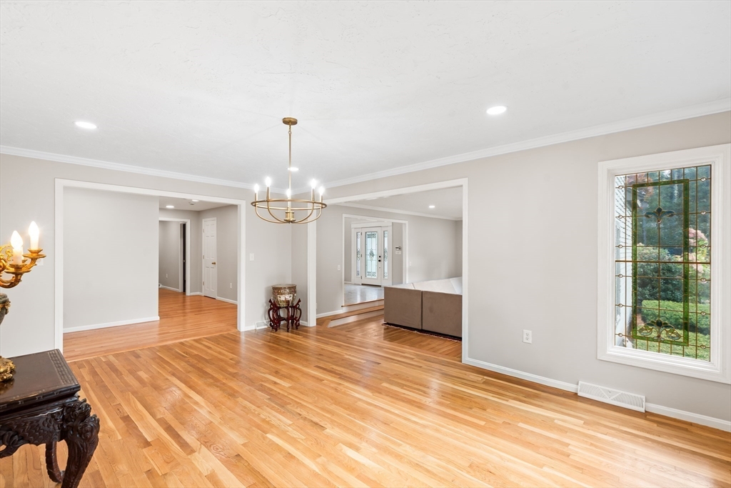 7 Saddle Ridge Road Sudbury, MA 01776 - Photo 17 of 42 a view of a livingroom with wooden floor and a ceiling fan