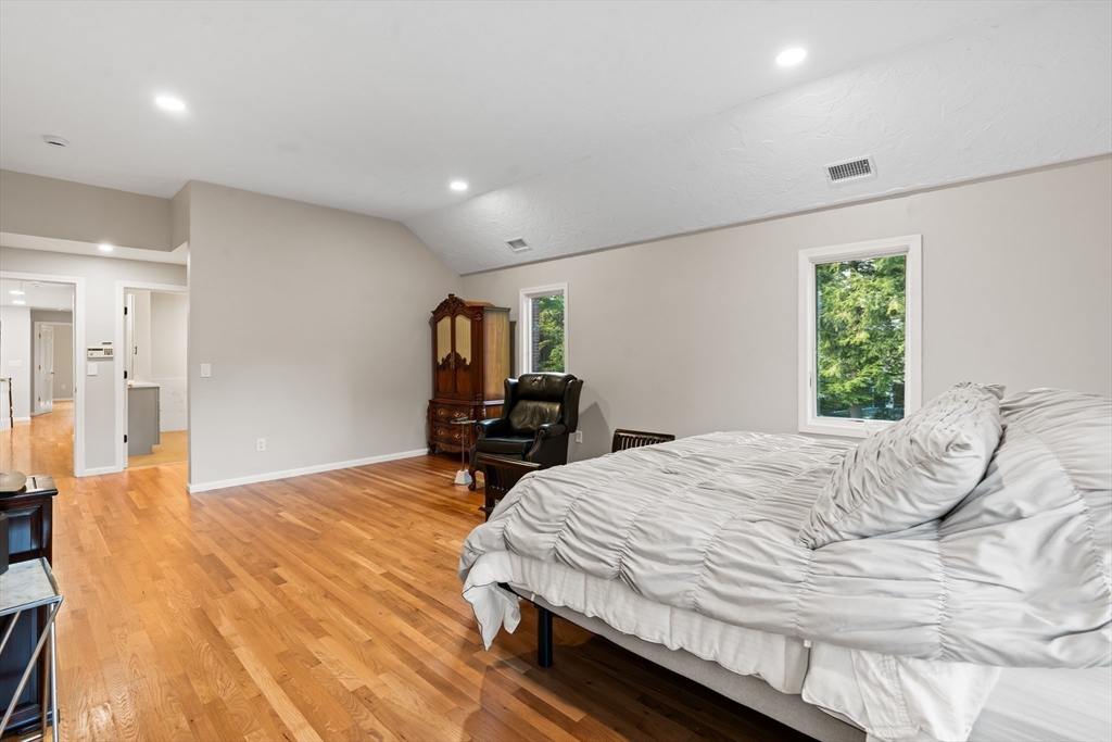 7 Saddle Ridge Road Sudbury, MA 01776 - Photo 28 of 42 a bedroom with a bed and wooden floor