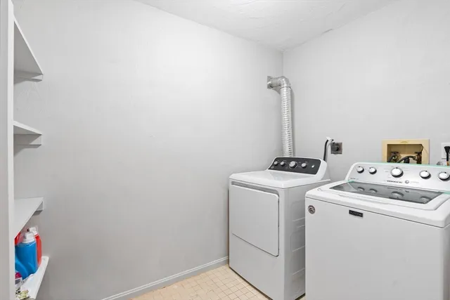 a view of storage and utility room with washer and dryer