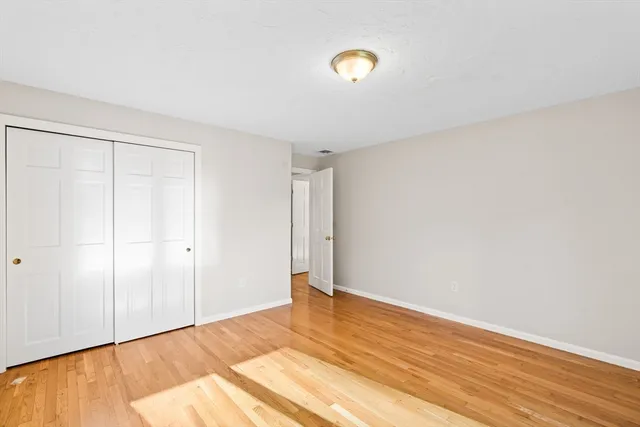a view of an empty room and wooden floor