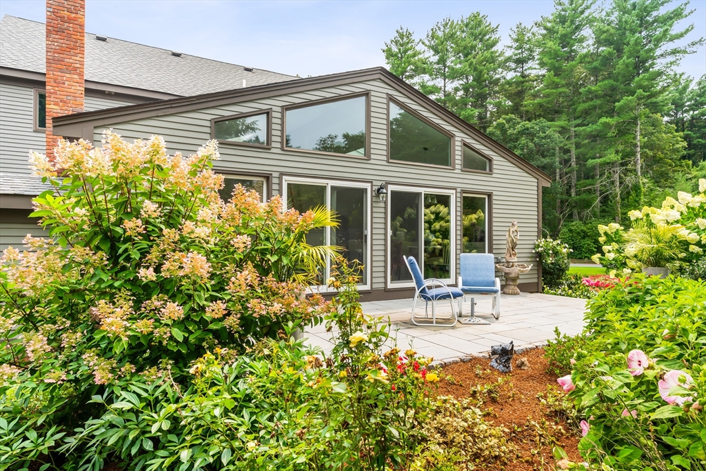 7 Saddle Ridge Road Sudbury, MA 01776 - Photo 5 of 42 a front view of a house with a garden and sitting area
