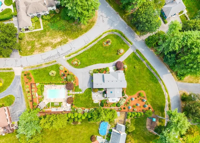 an aerial view of a house with a swimming pool