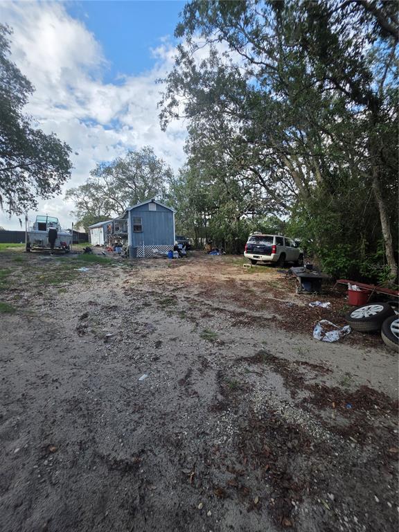 17820 Monteverde Drive Spring Hill, FL 34610 - Photo 40 of 42 a view of a yard with car parked