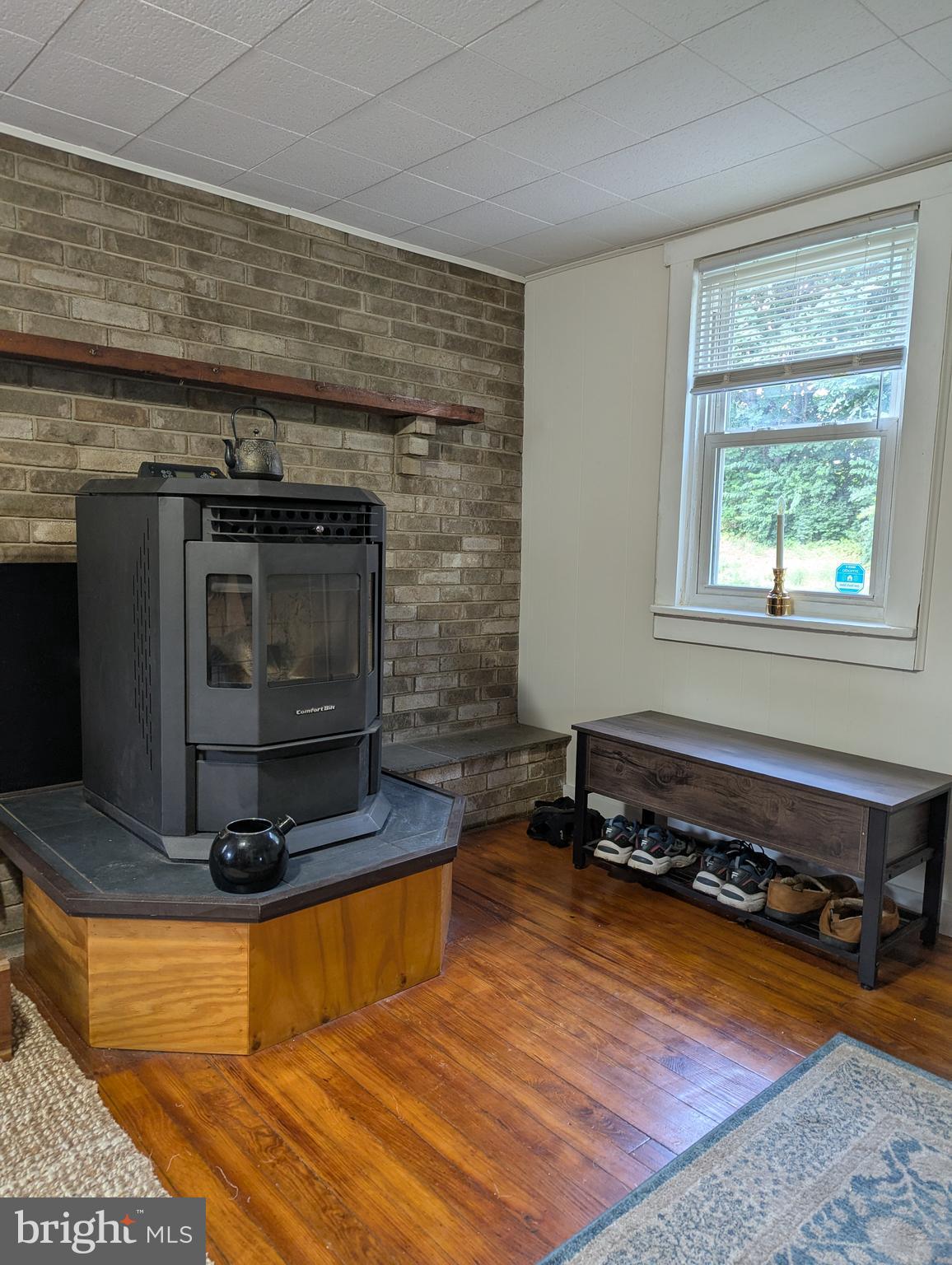 2812 Hossler Road Manheim, PA 17545 - Photo 5 of 45 a living room with a fireplace wooden floor and a table