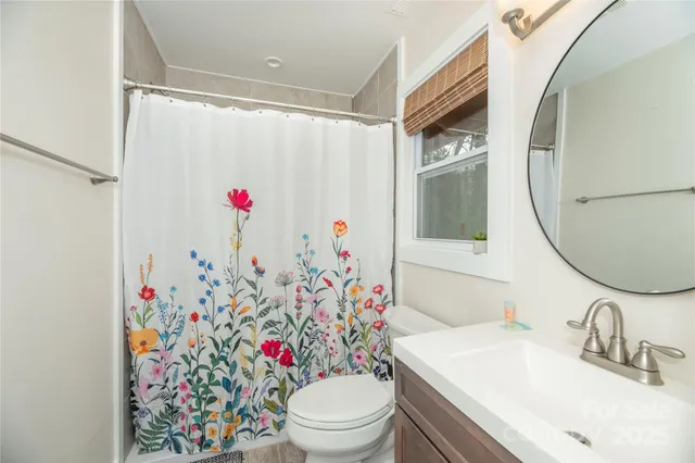 a bathroom with a sink toilet and a mirror