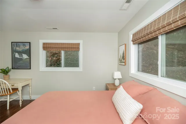 a bedroom with a bed and a large window