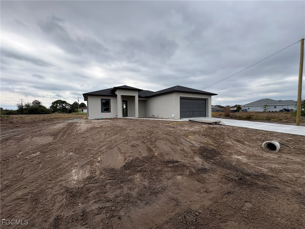 2503 45th Street Southwest Lehigh Acres, FL 33976 - Photo 5 of 7 a view of a house with backyard and trees