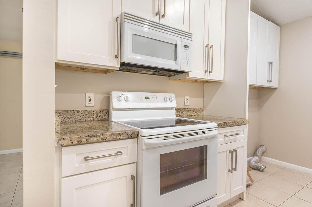 10225 Sleepy Brook Way Boca Raton, FL 33428 - Photo 13 of 41 a stove top oven sitting inside of a kitchen