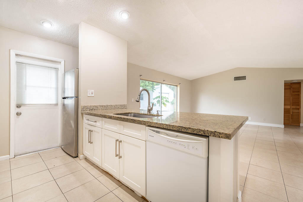 10225 Sleepy Brook Way Boca Raton, FL 33428 - Photo 14 of 41 a bathroom with a granite countertop sink and a mirror