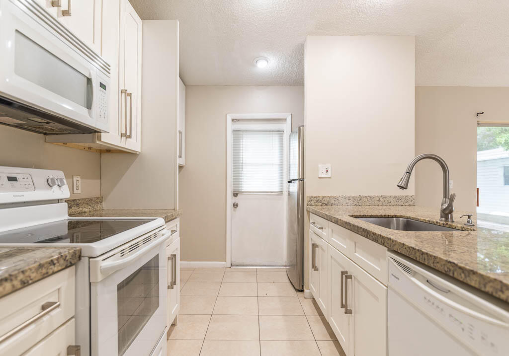 10225 Sleepy Brook Way Boca Raton, FL 33428 - Photo 15 of 41 a kitchen with a sink and a stove top oven
