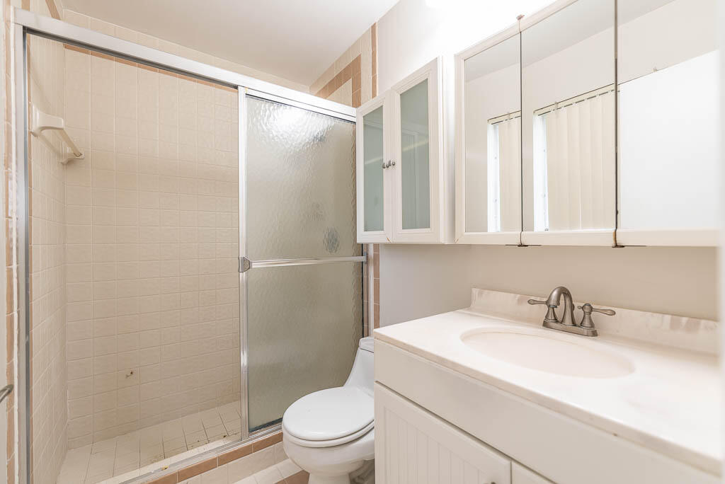 10225 Sleepy Brook Way Boca Raton, FL 33428 - Photo 20 of 41 a bathroom with a granite countertop sink toilet and shower