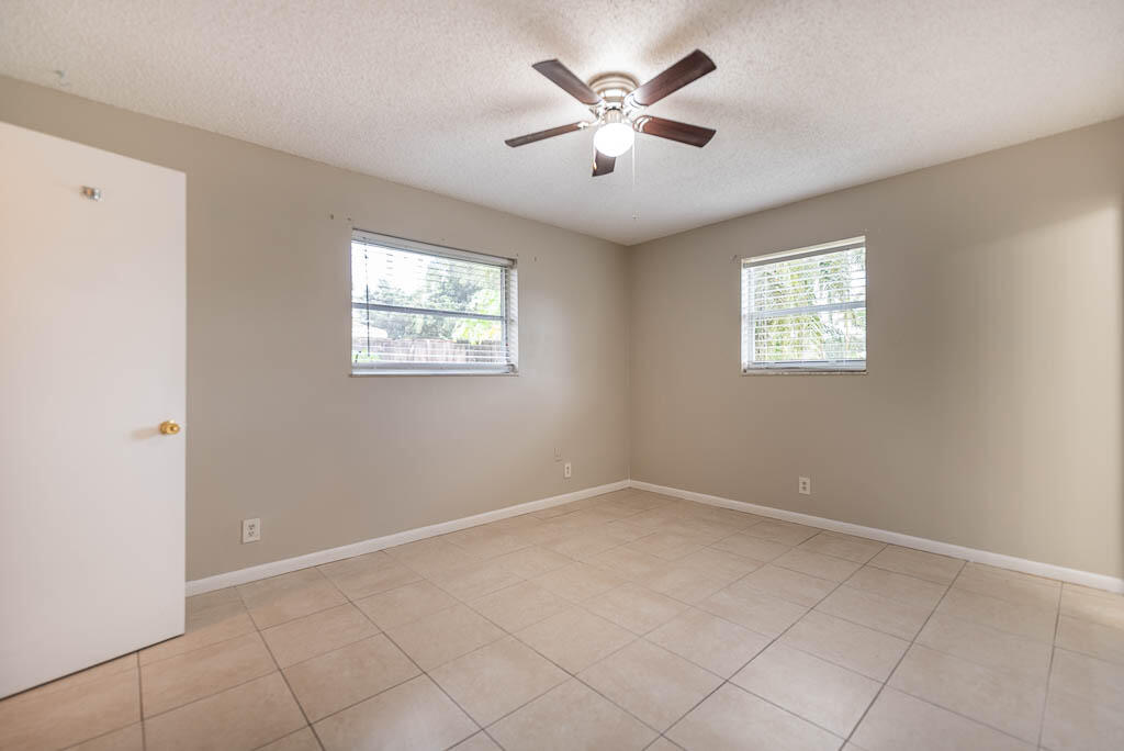 10225 Sleepy Brook Way Boca Raton, FL 33428 - Photo 22 of 41 an empty room with windows and fan
