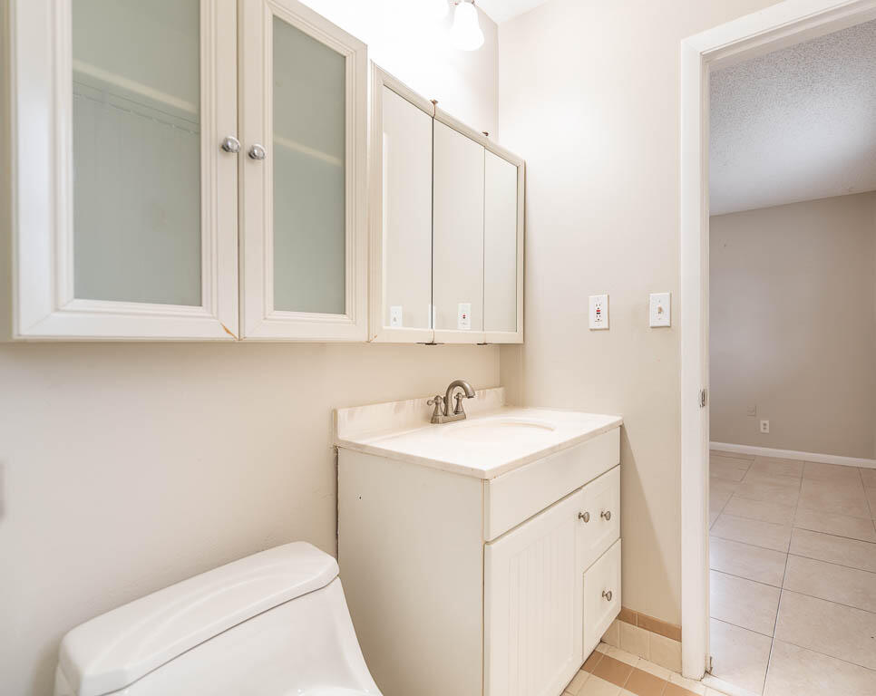 10225 Sleepy Brook Way Boca Raton, FL 33428 - Photo 24 of 41 a bathroom with a sink a toilet and a mirror