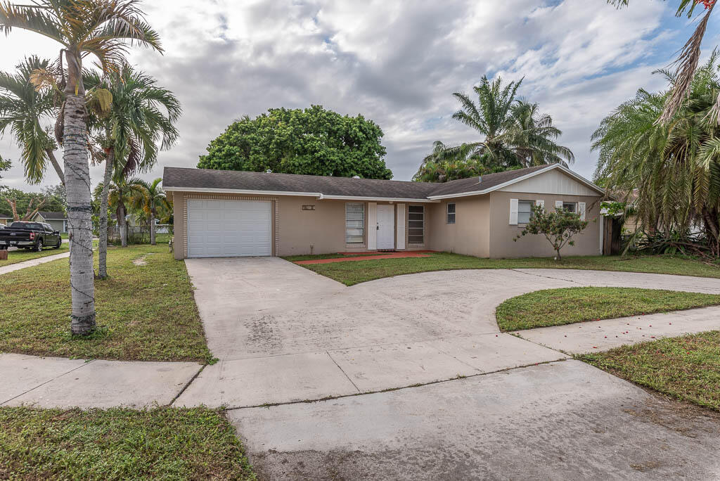 10225 Sleepy Brook Way Boca Raton, FL 33428 - Photo 3 of 41 a front view of a house with garden