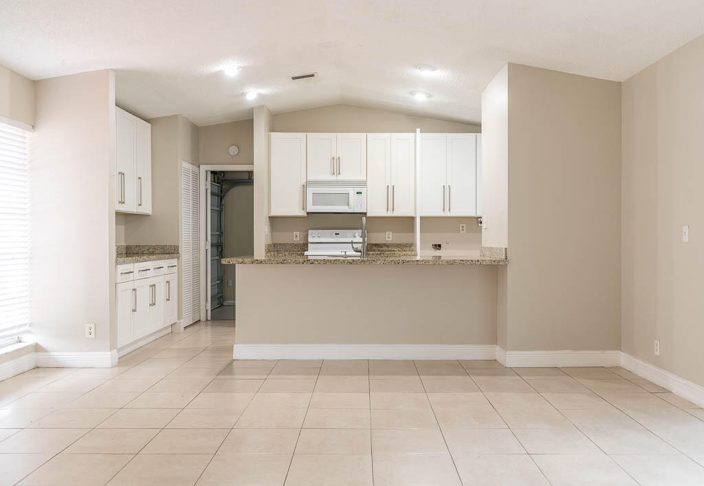 10225 Sleepy Brook Way Boca Raton, FL 33428 - Photo 31 of 41 a kitchen with stainless steel appliances a refrigerator sink and cabinets