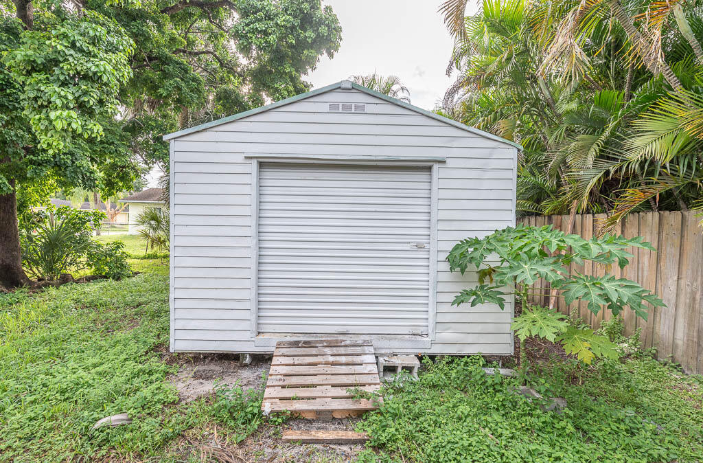 10225 Sleepy Brook Way Boca Raton, FL 33428 - Photo 6 of 41 a white house with a small yard and plants