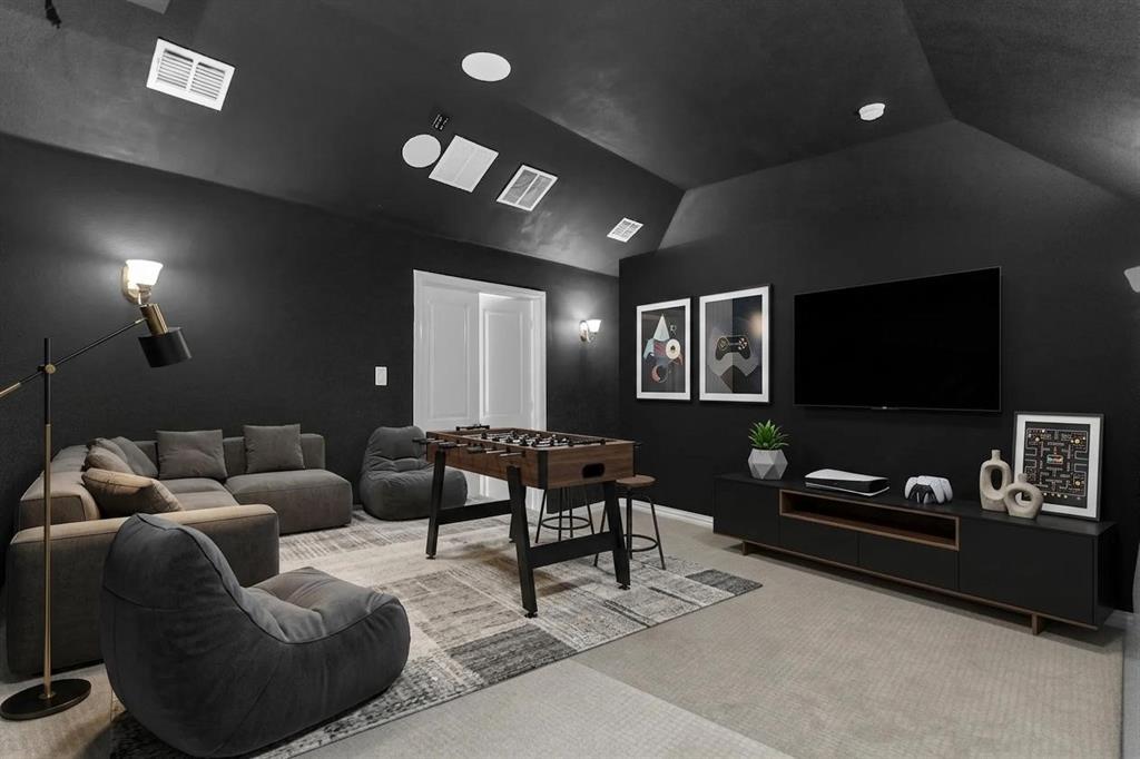 6333 Hall Road Frisco, TX 75034 - Photo 27 of 38 Media room featuring dark wall finishes, vaulted ceiling, and recessed lighting
