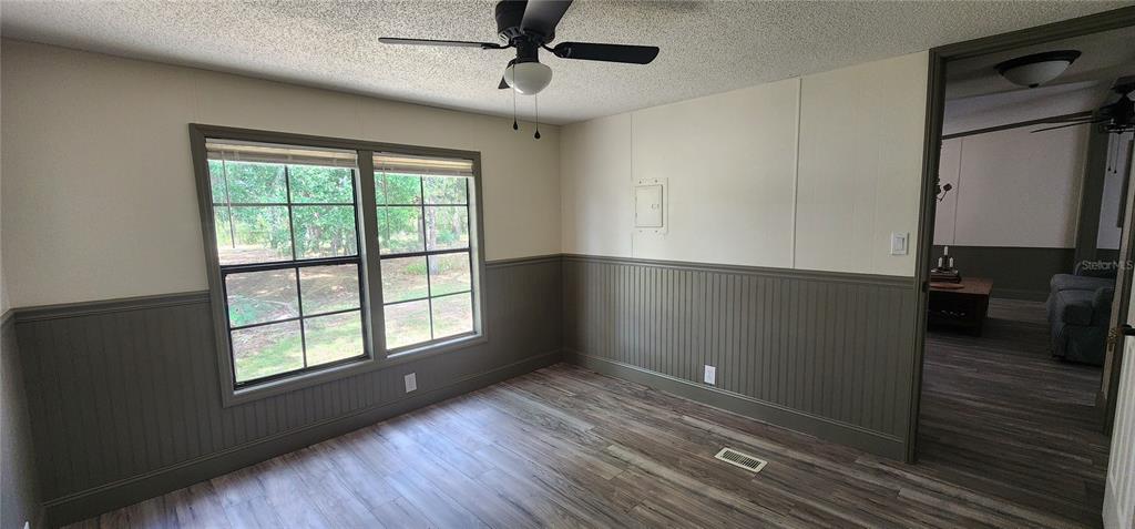 19865 Southwest 5th Place Dunnellon, FL 34431 - Photo 62 of 78 a view of an empty room with a window and wooden floor