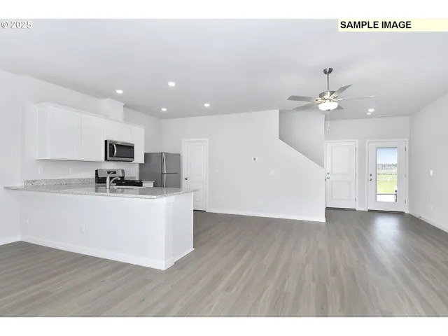 a view of kitchen with sink microwave and stove
