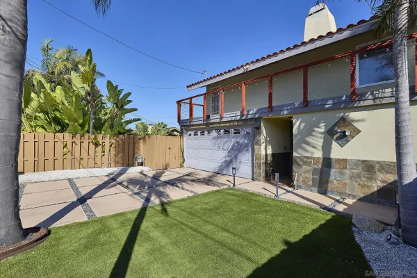 a view of backyard with a patio and a garden