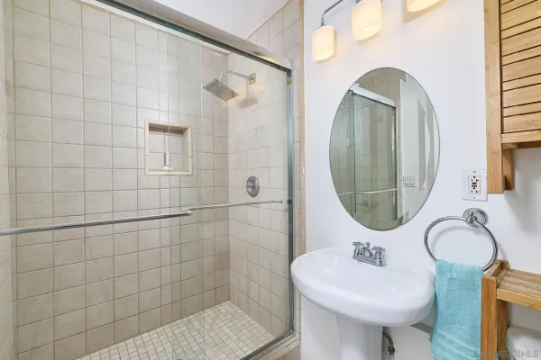 a bathroom with a sink a toilet and a mirror