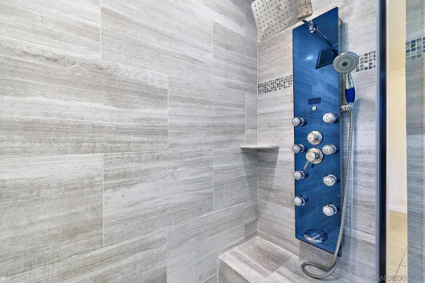 a bathroom with a granite countertop sink a toilet and a large mirror