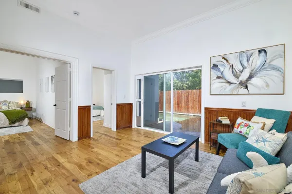 a living room with furniture a rug and a wall painting