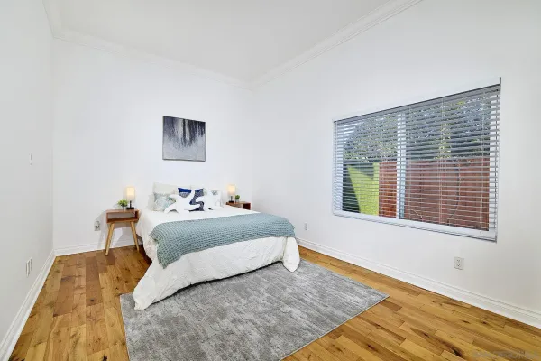 a bedroom with a bed and a window