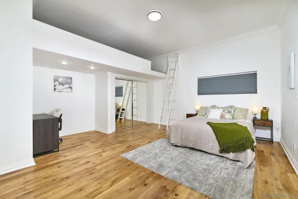 a spacious bedroom with a bed and a couch