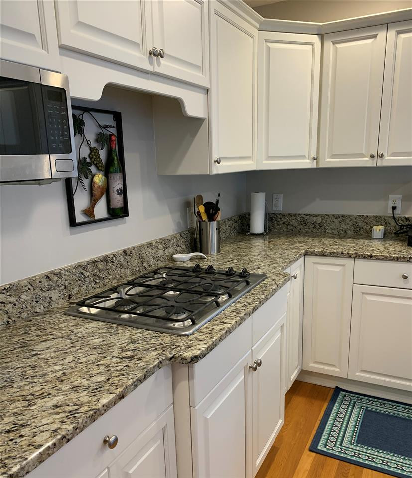 10325 Old Warden Road Raleigh, NC 27615 - Photo 2 of 3 a kitchen with white cabinets and sink