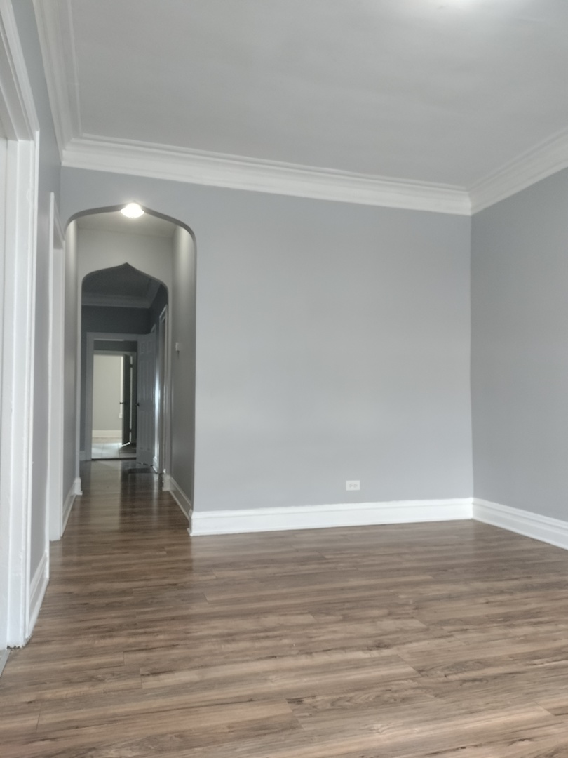 705 East 92nd Street Chicago, IL 60619 - Photo 7 of 23 a view of a room with wooden floor