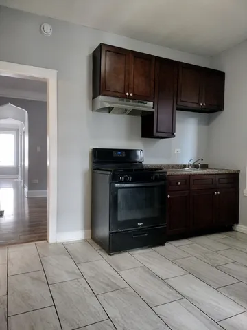 a kitchen with stainless steel appliances granite countertop a stove and a microwave