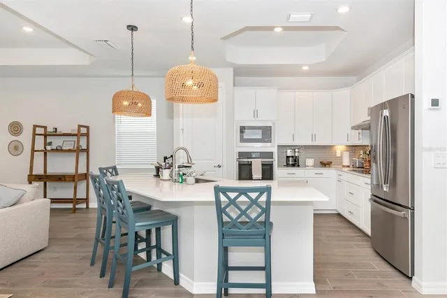a living room with furniture a flat screen tv and a large window