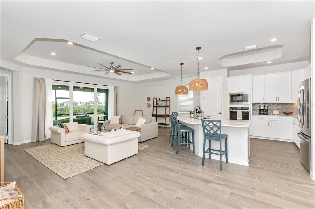 17672 Santorini Court Venice, FL 34293 - Photo 18 of 94 a living room with furniture a dining table and chairs