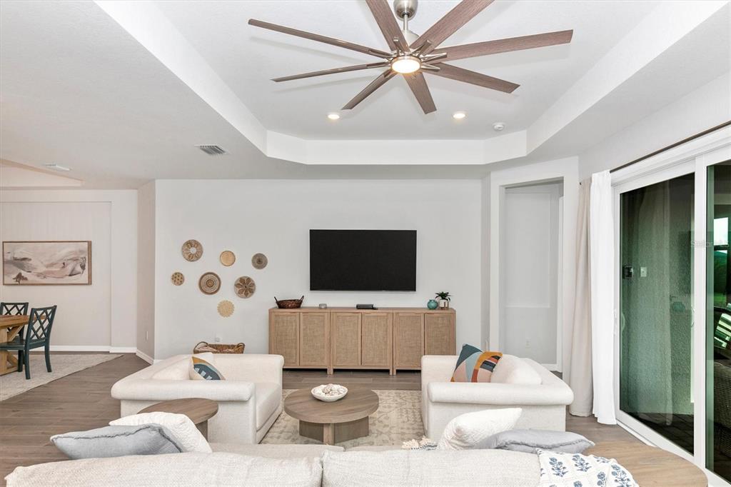 17672 Santorini Court Venice, FL 34293 - Photo 20 of 94 a living room with furniture and a flat screen tv