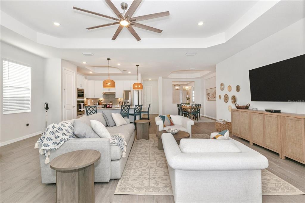 17672 Santorini Court Venice, FL 34293 - Photo 21 of 94 a living room with furniture and a flat screen tv