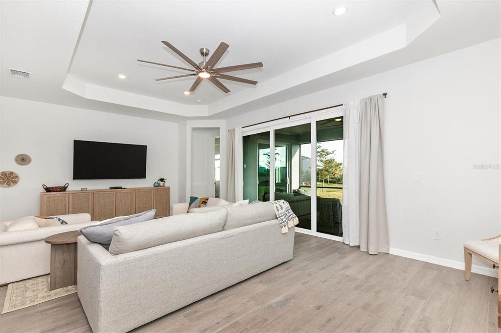 17672 Santorini Court Venice, FL 34293 - Photo 22 of 94 a living room with furniture and a flat screen tv
