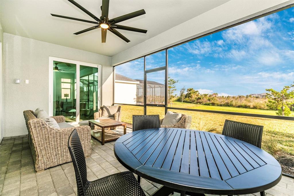 17672 Santorini Court Venice, FL 34293 - Photo 25 of 94 a living room with furniture and a large window