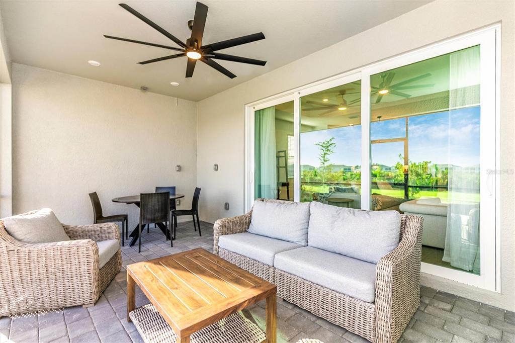 17672 Santorini Court Venice, FL 34293 - Photo 26 of 94 a living room with furniture and a large window