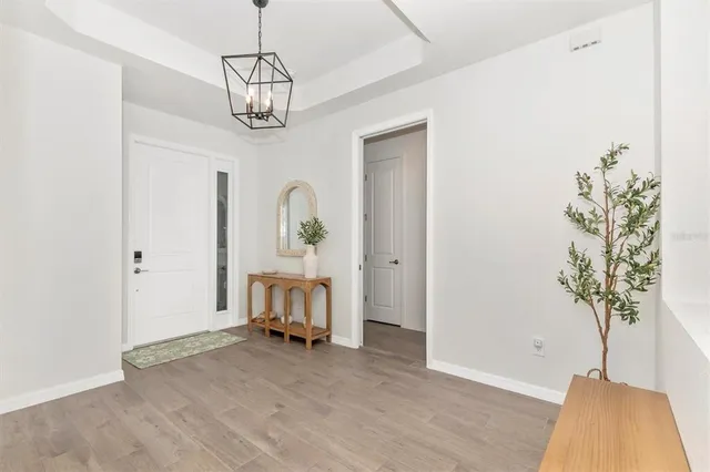 a dining room with wooden floor and a rug