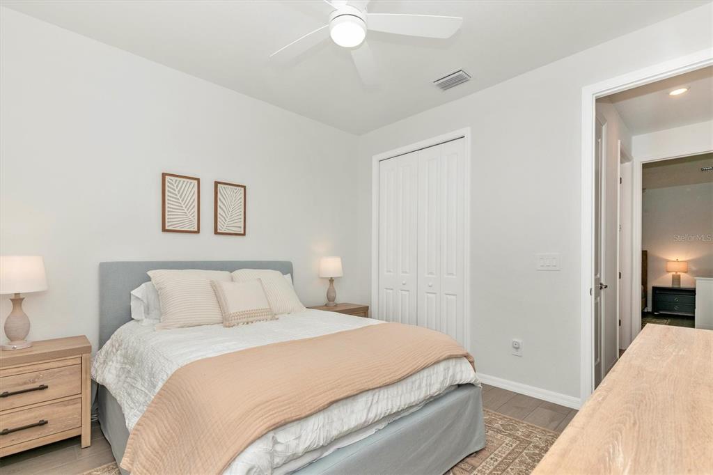 17672 Santorini Court Venice, FL 34293 - Photo 36 of 94 a bedroom with a bed and a lamp