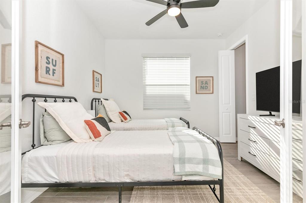 17672 Santorini Court Venice, FL 34293 - Photo 37 of 94 a bedroom with a bed and a flat screen tv