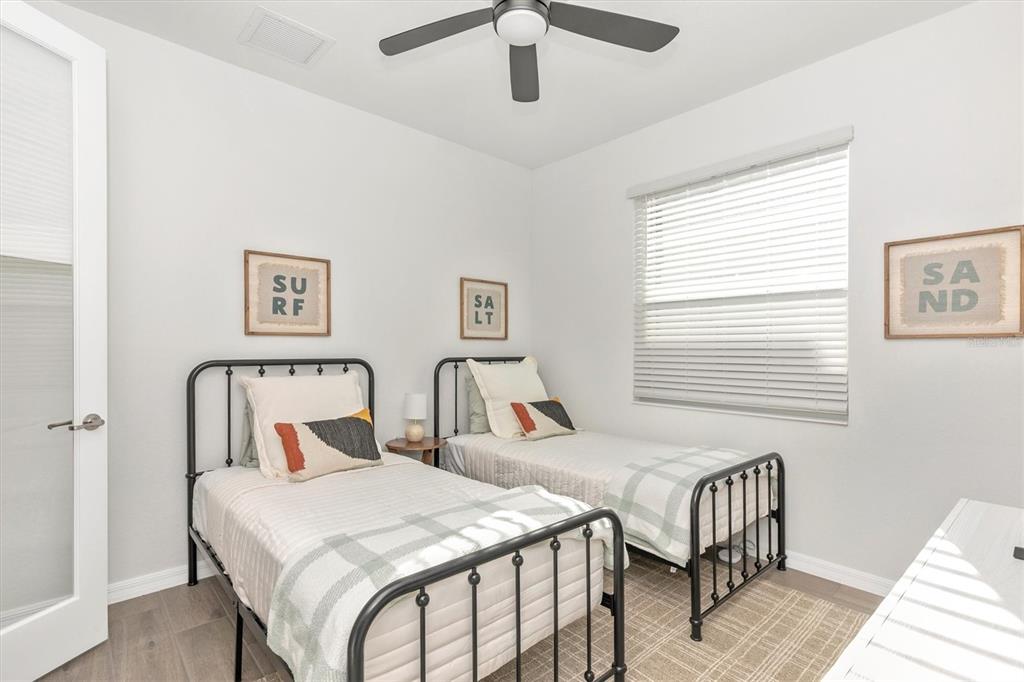 17672 Santorini Court Venice, FL 34293 - Photo 38 of 94 a bedroom with two beds and a table
